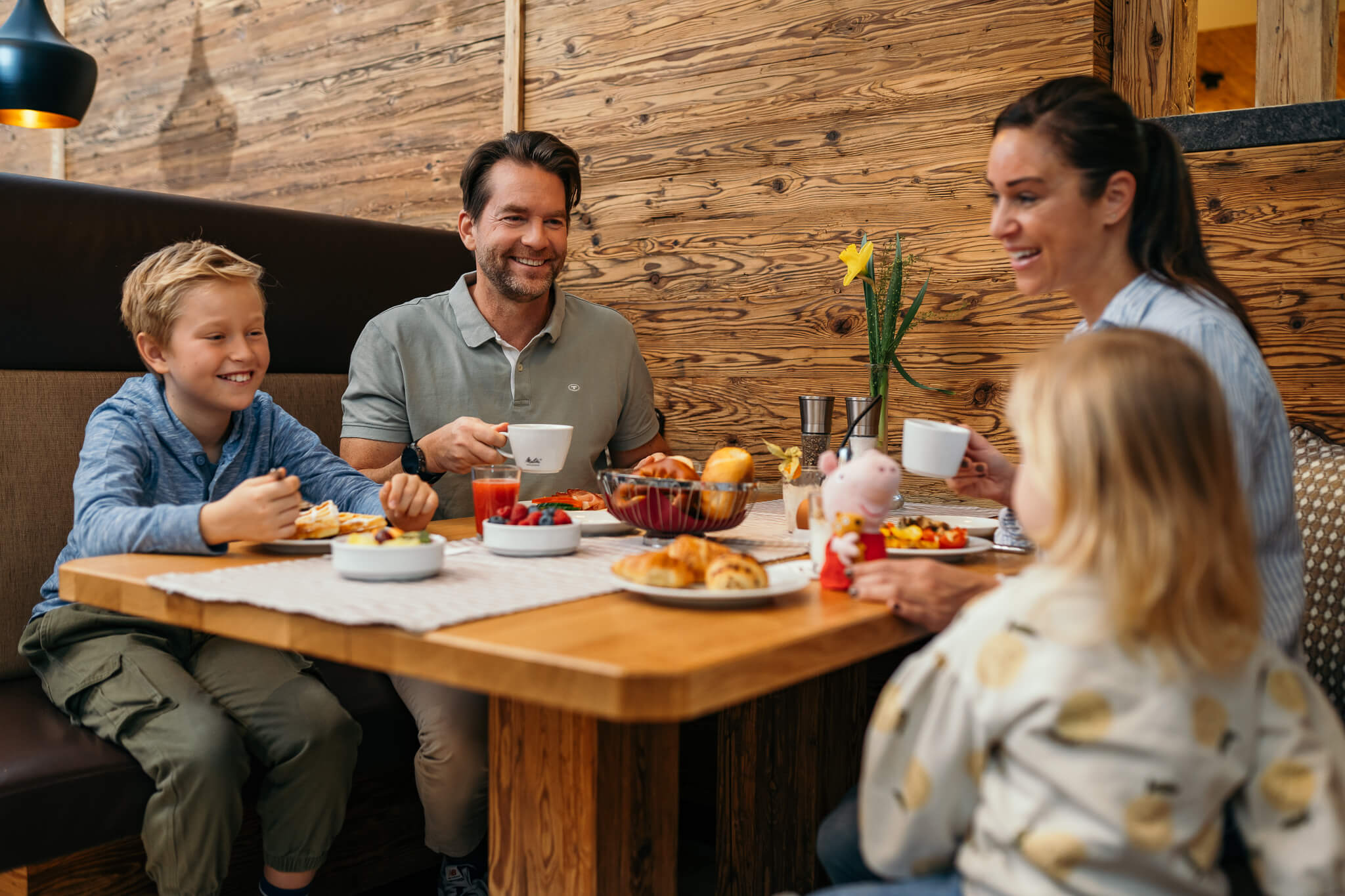 Familiennestl Seeblick II Familie mit zwei Kindern isst Frühstück an Holztisch in gemütlichem Restaurant