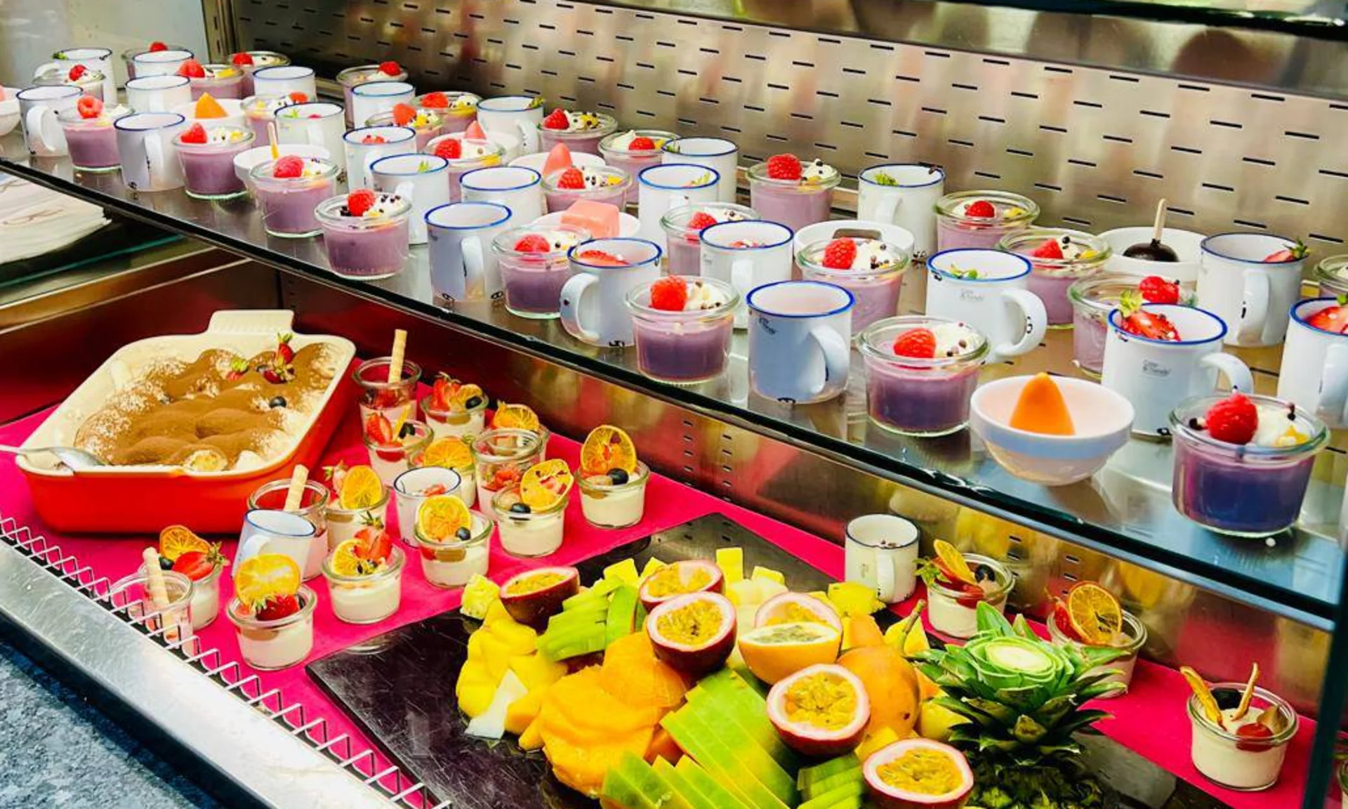 Welcome to our family hotel at Lake Achensee. Buffet with various desserts and fresh fruit in glasses and cups